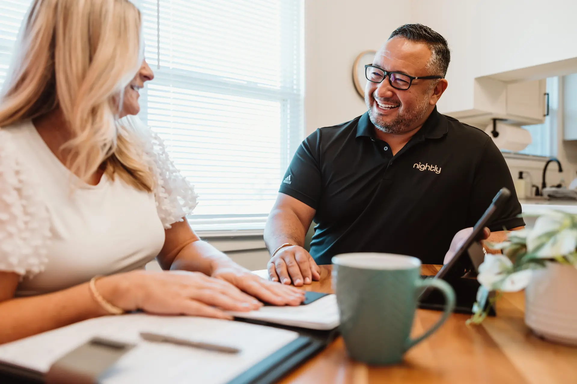 A Nightly team member reviewing a revenue projection with a homeowner